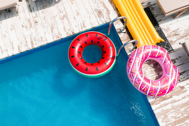 Image of Above view of inflatable rings and swimming pool. Summer vacation