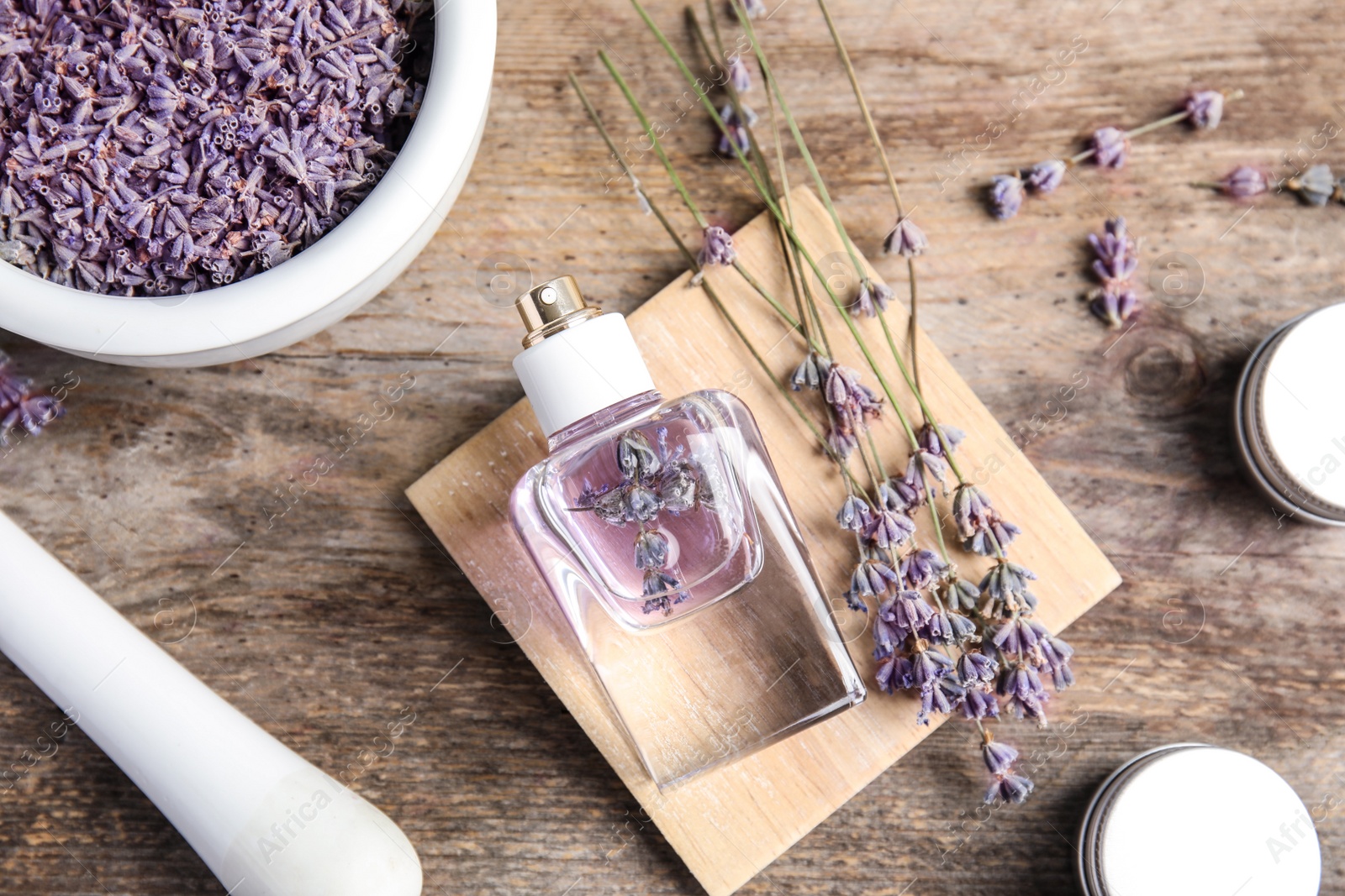 Photo of Flat lay composition with lavender flowers and natural cosmetic on wooden background