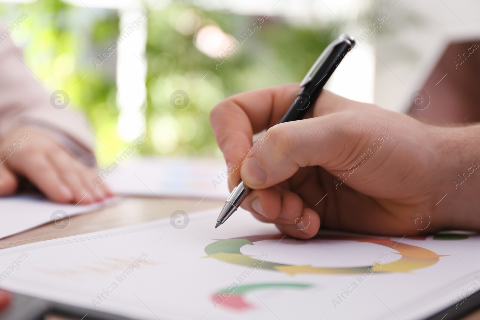 Photo of Business people working with charts and graphs at table in office, closeup. Investment analysis