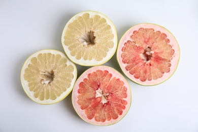 Photo of Fresh cut pomelo fruits on white background, top view