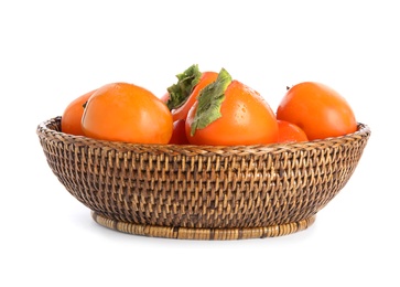 Photo of Wicker bowl with delicious persimmons isolated on white