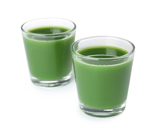Photo of Fresh wheat grass juice in glasses on white background