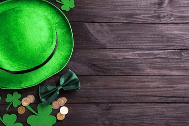 Leprechaun's hat and St. Patrick's day decor on black wooden background, flat lay. Space for text