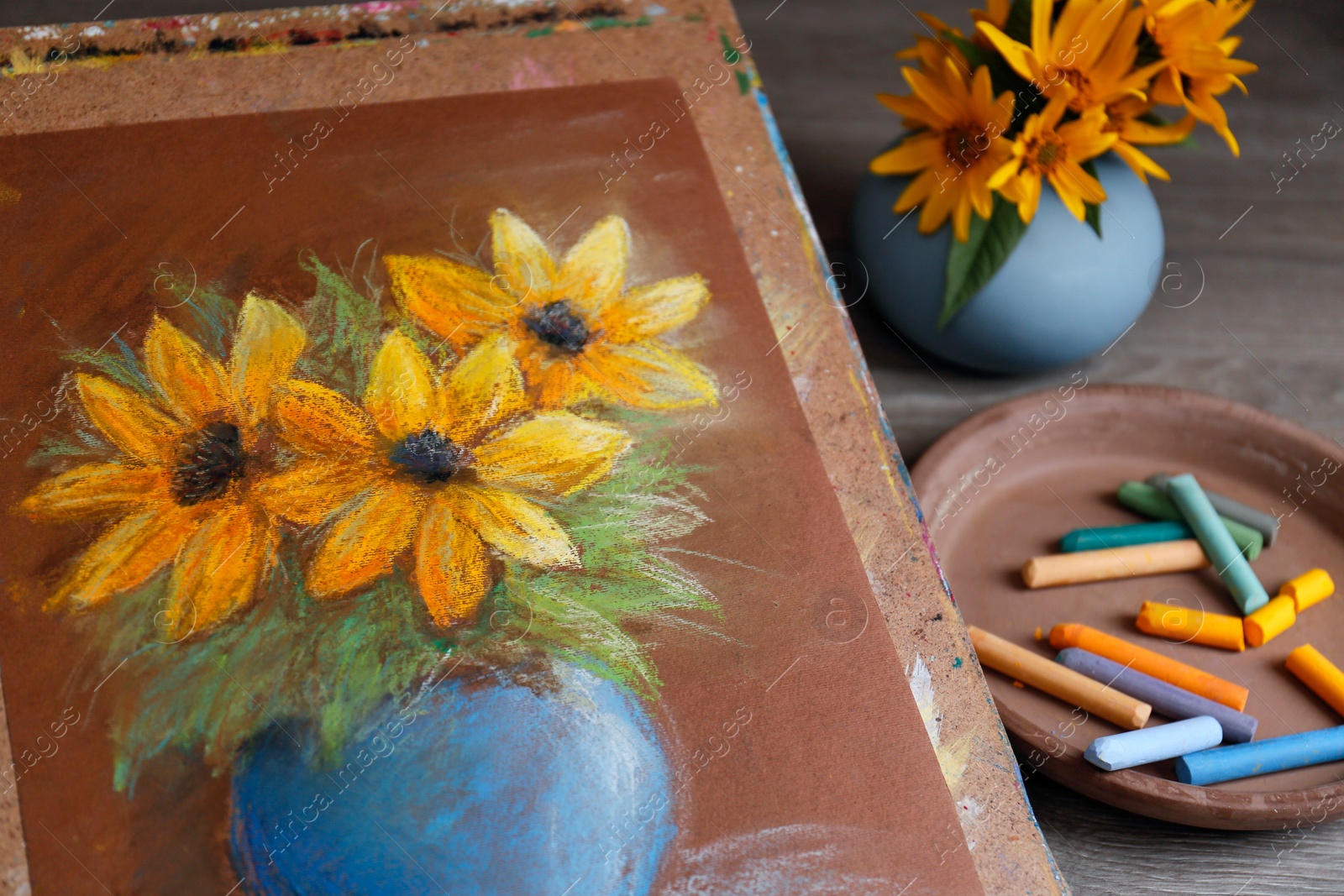 Photo of Pastel drawing of beautiful yellow flowers in vase on table