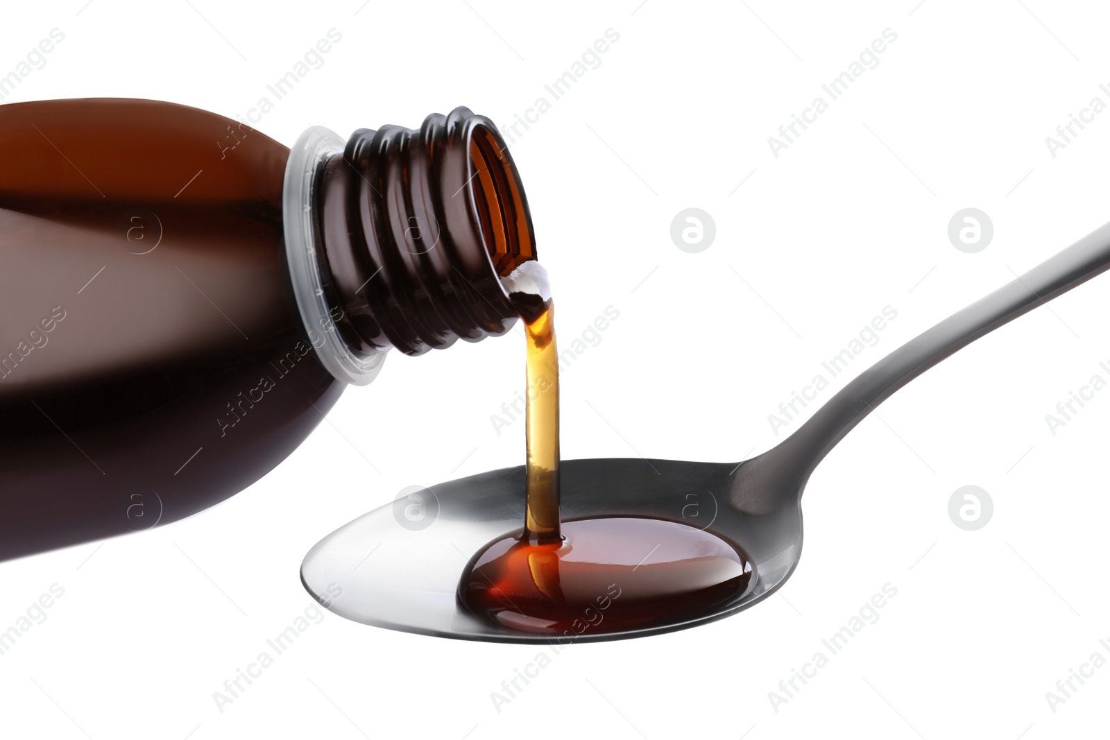 Photo of Pouring syrup into spoon from bottle isolated on white, closeup. Cough and cold medicine