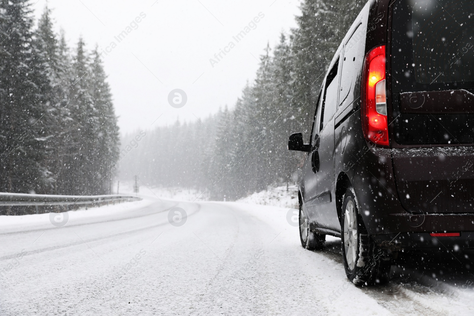 Photo of Country road with car on snowy winter day. Space for text