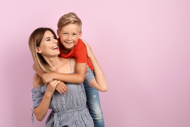 Photo of Portrait of mother and son on color background