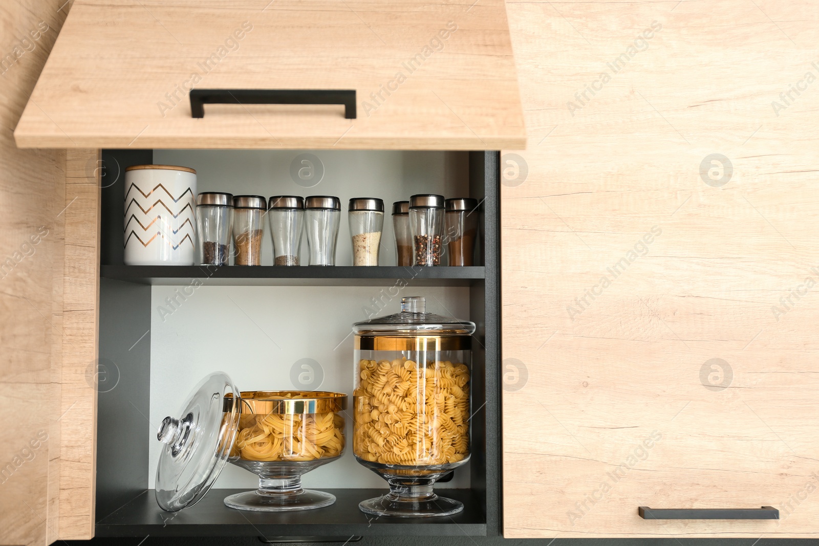 Photo of Products in modern kitchen glass containers on shelf