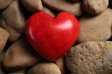 Red decorative heart on stones, above view