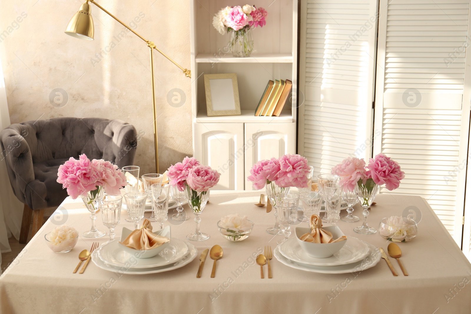 Photo of Stylish table setting with beautiful peonies and fabric napkins indoors