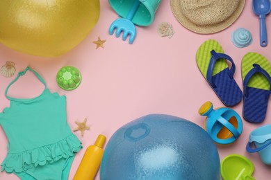 Photo of Composition with beach balls and sand toys on pink background, flat lay. Space for text