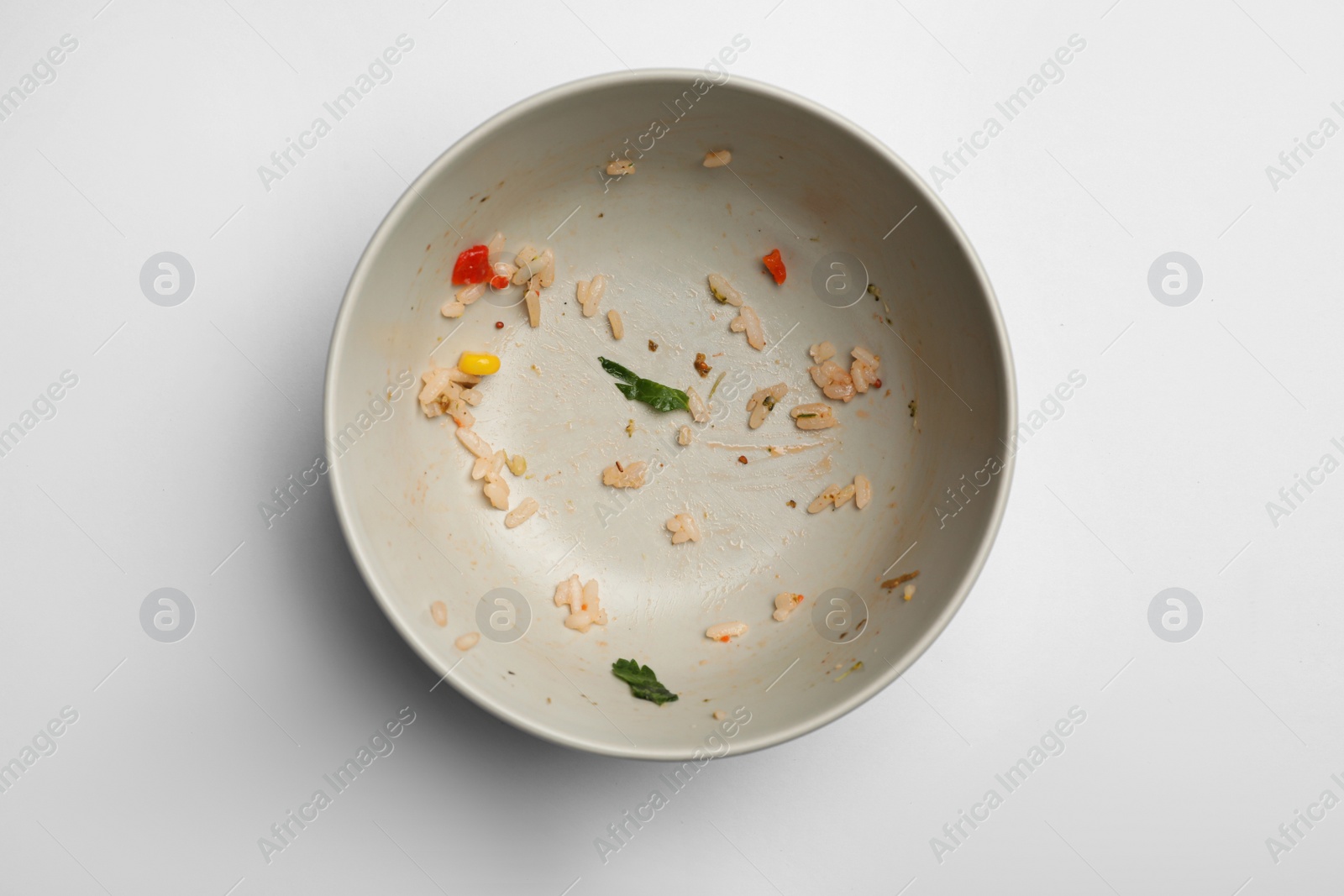 Photo of Dirty bowl with food leftovers on white background, top view