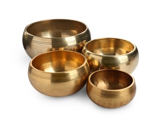 Photo of Four Tibetan singing bowls on white background