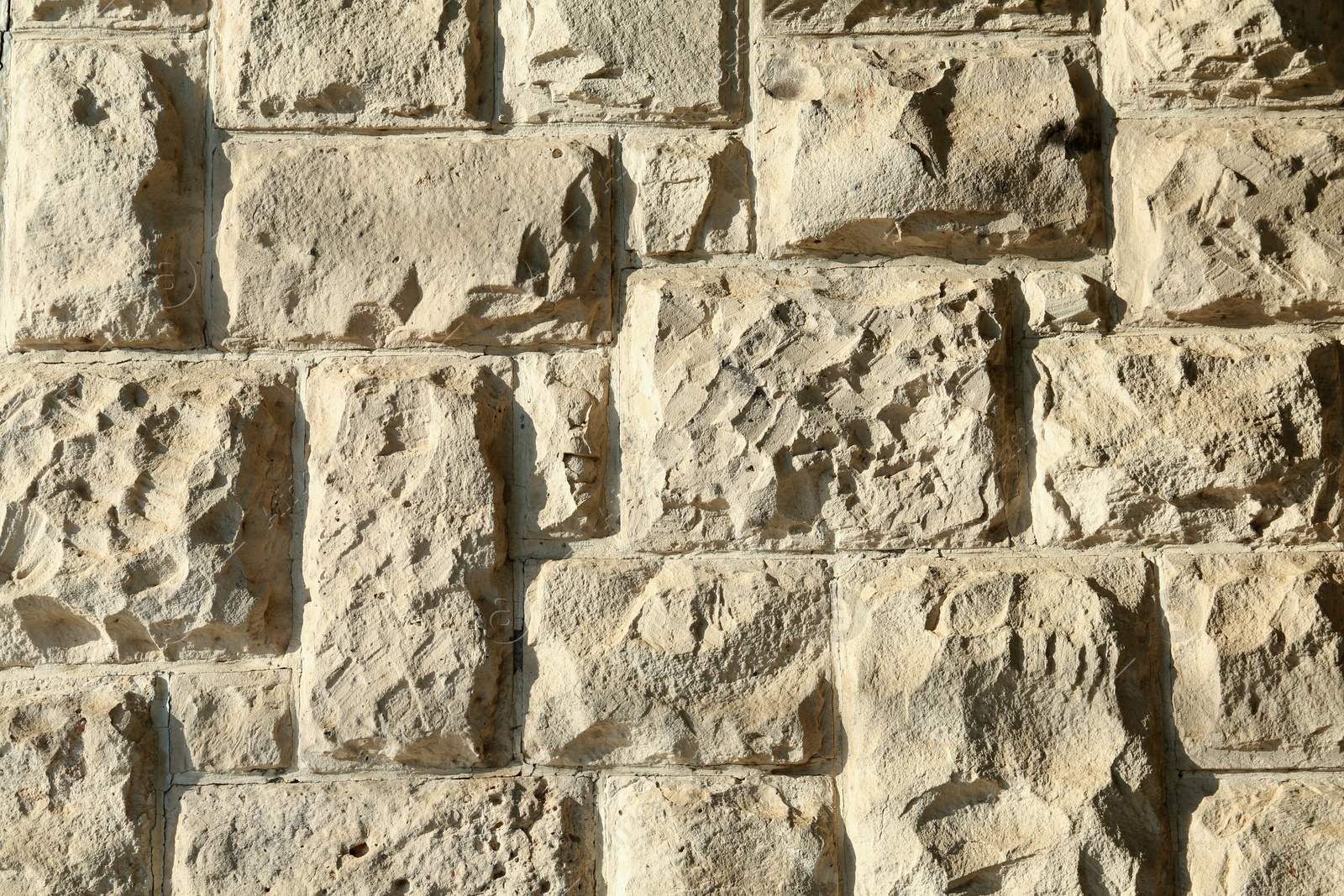 Photo of Texture of beige brick wall as background