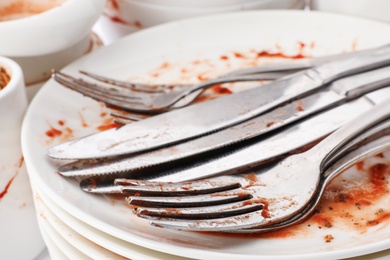 Pile of dirty dishes and cutlery, closeup