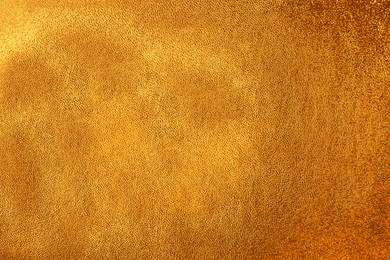 Texture of golden leather as background, closeup