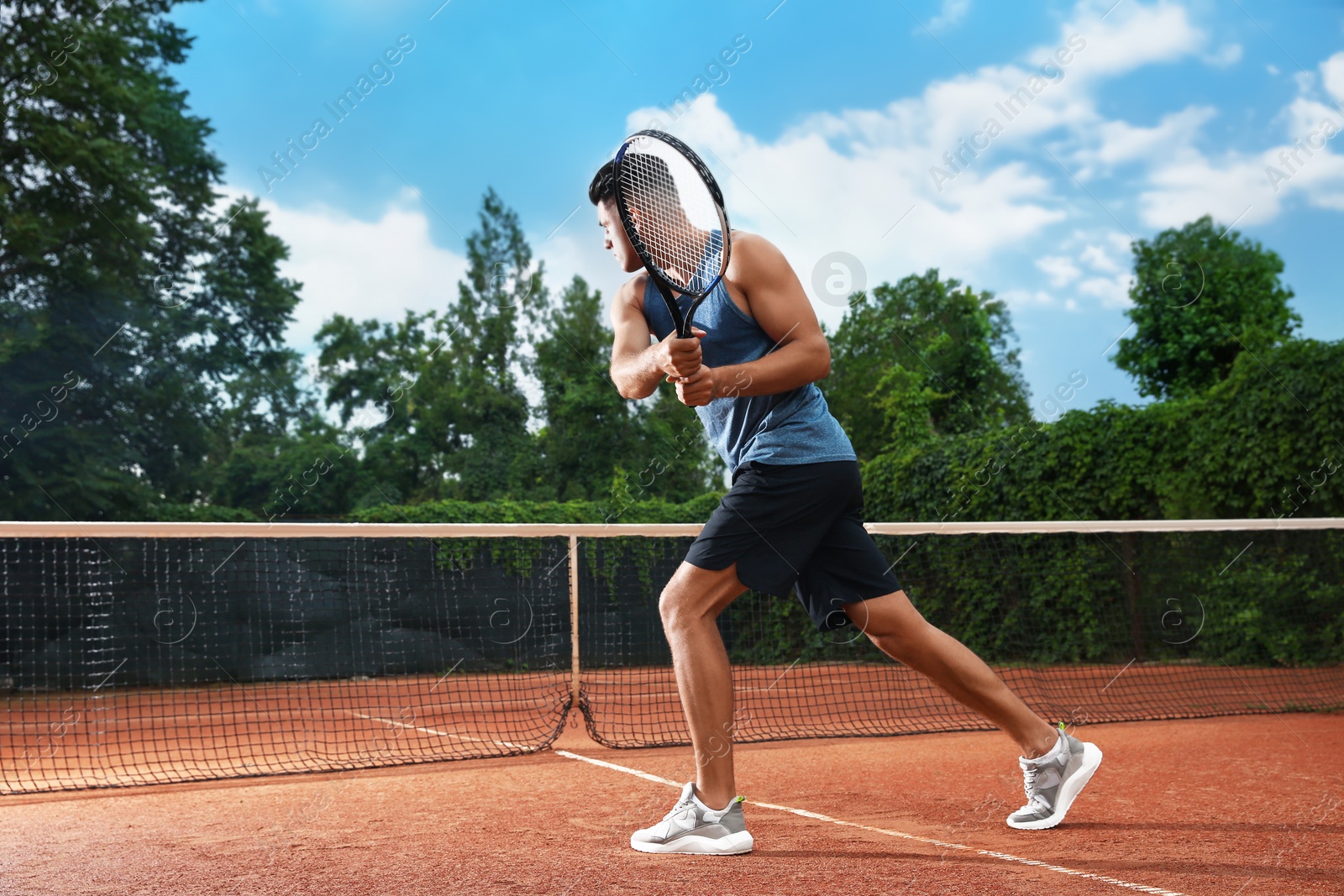 Photo of Man playing tennis on court. Racket sport