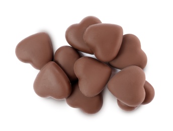 Delicious heart shaped chocolate candies on white background, top view