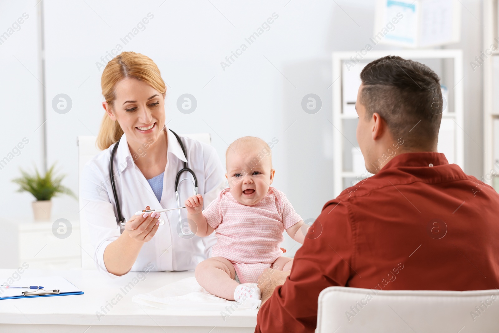 Photo of Man with his baby visiting children's doctor in hospital