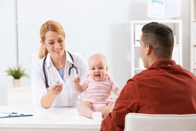 Man with his baby visiting children's doctor in hospital