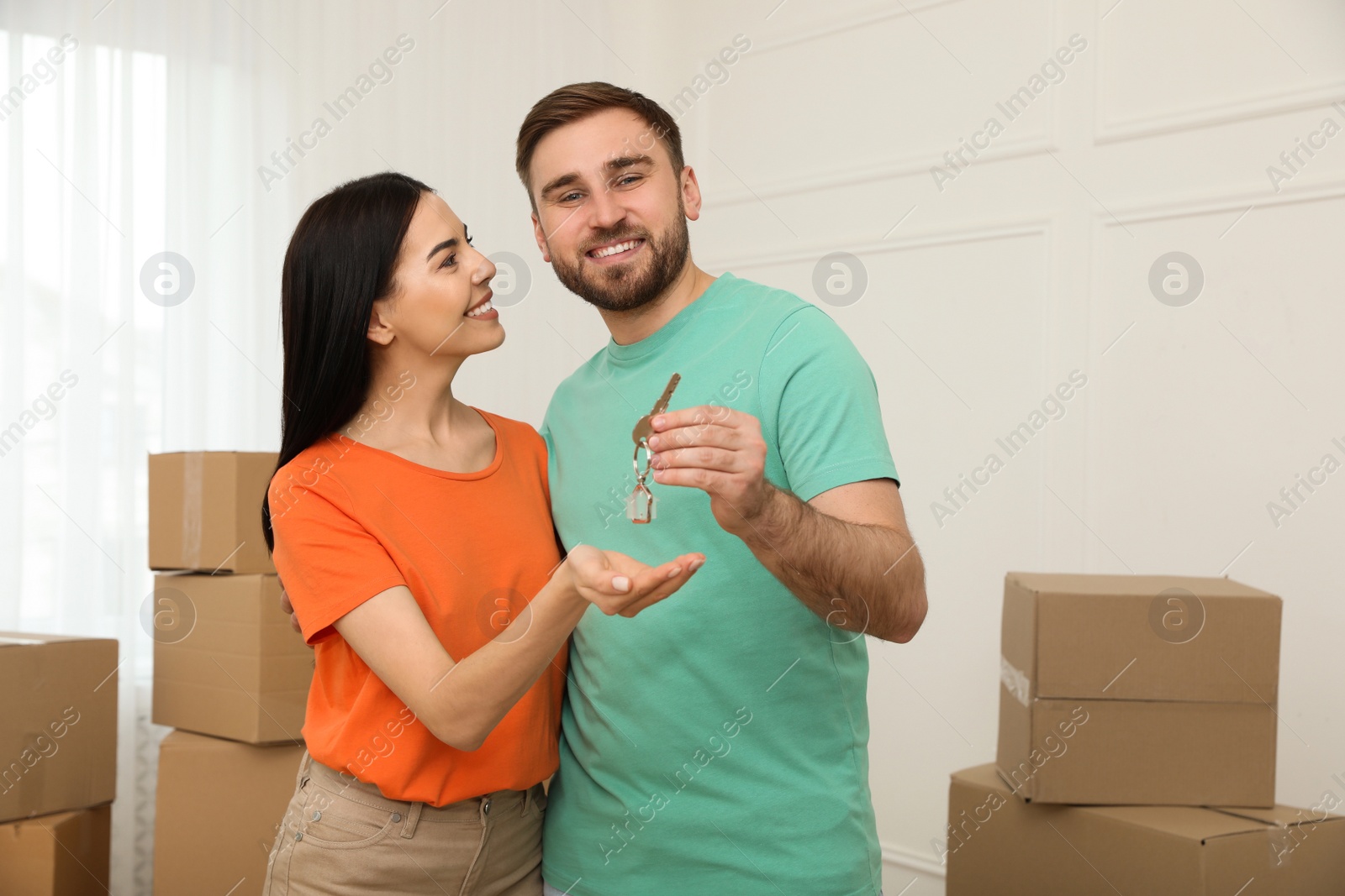 Photo of Happy young couple with key in new house