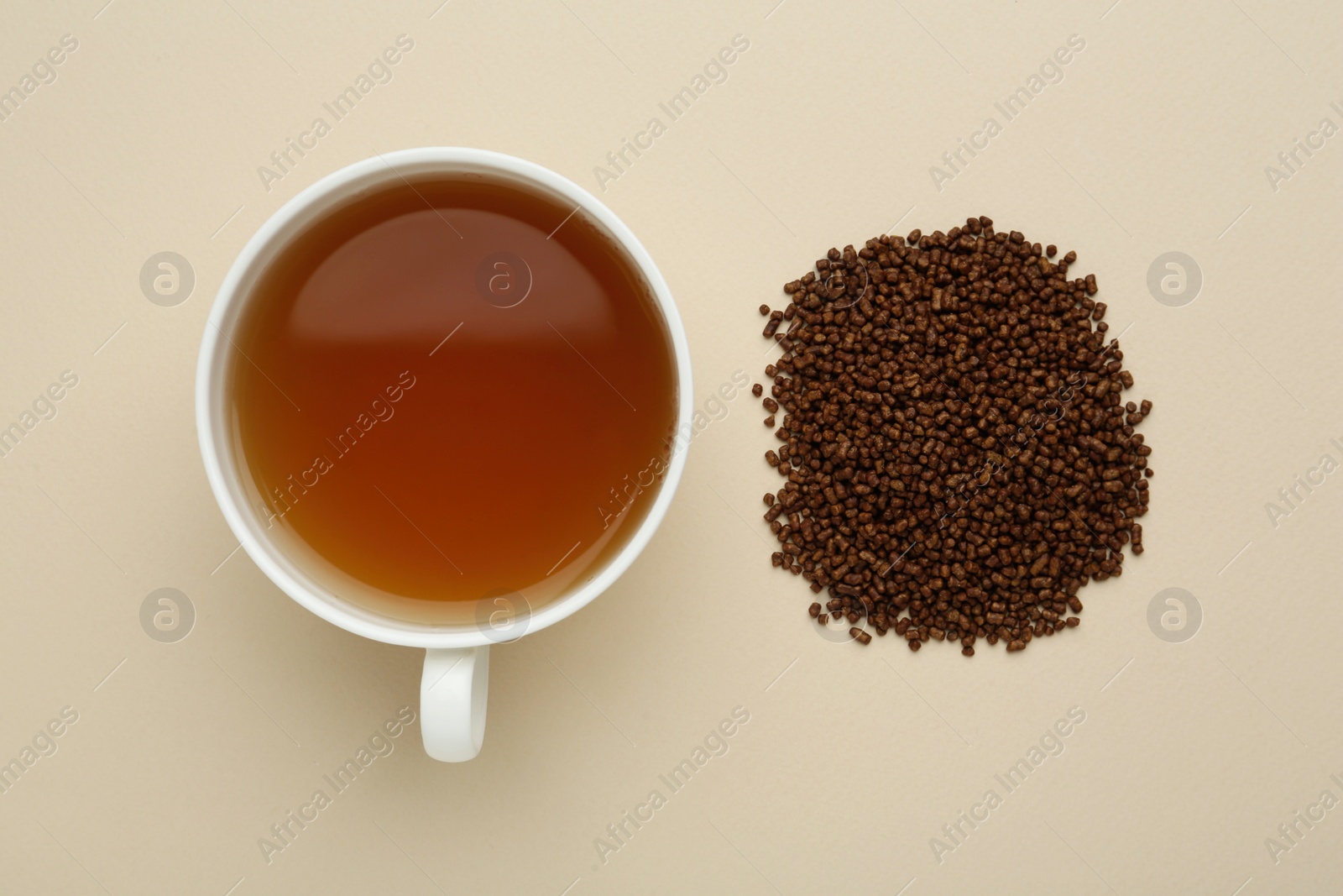 Photo of Buckwheat tea and granules on beige background, flat lay