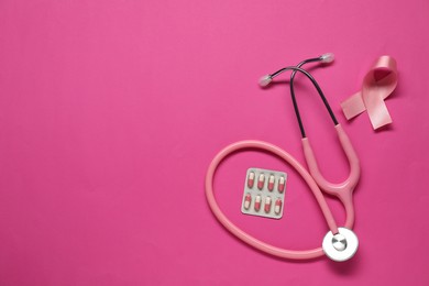 Photo of Breast cancer awareness. Pink ribbon, stethoscope and pills on color background, flat lay. Space for text