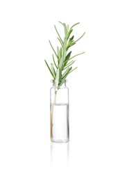 Photo of Bottle with essential oil and rosemary isolated on white
