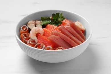 Photo of Delicious mackerel, shrimps, salmon and tuna served with parsley on white marble table, closeup. Tasty sashimi dish