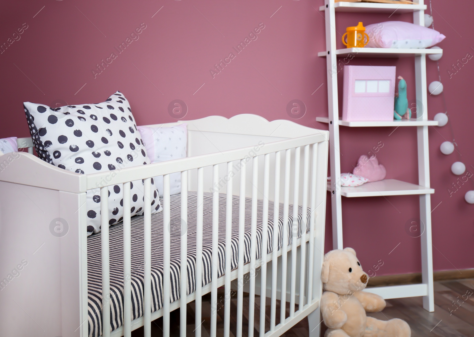 Photo of Stylish baby room interior with crib