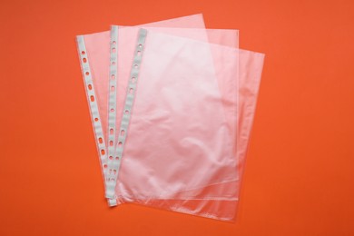 Photo of Punched pockets on orange background, flat lay