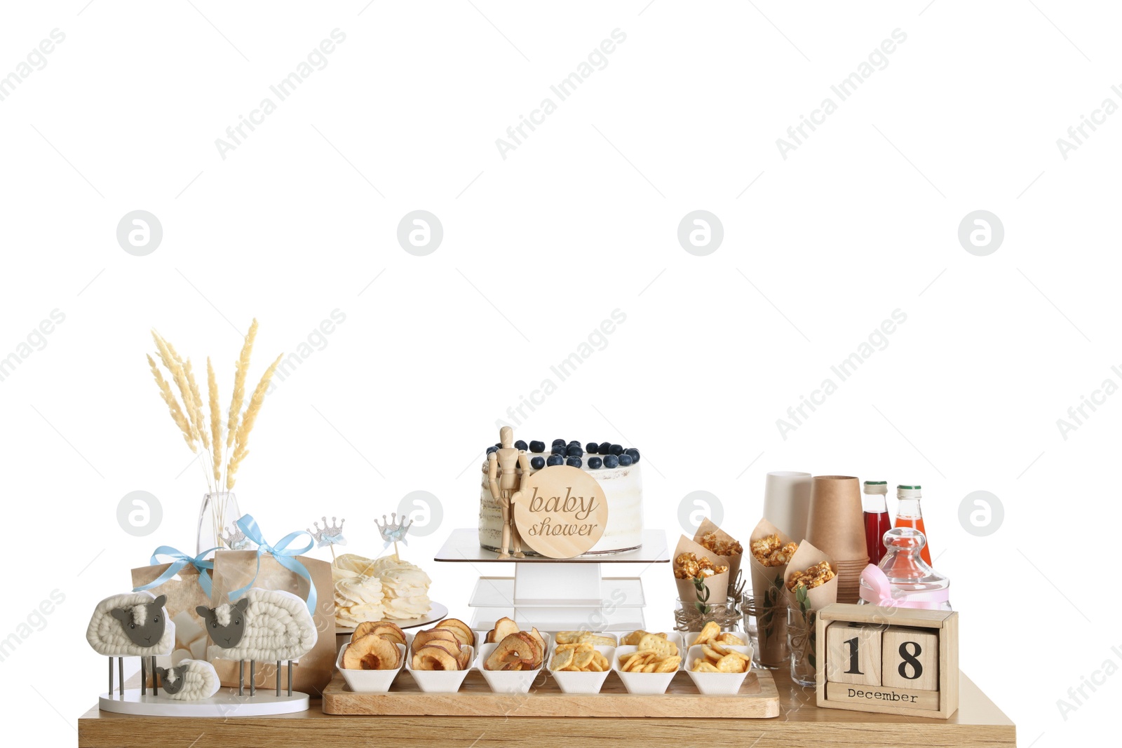 Photo of Baby shower party. Different delicious treats and decor on wooden table against white background