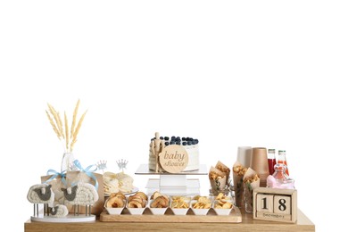 Photo of Baby shower party. Different delicious treats and decor on wooden table against white background