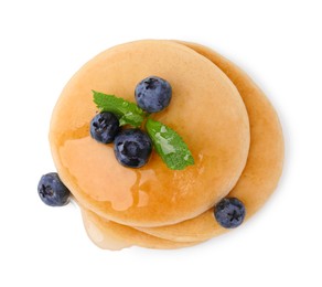 Tasty pancakes with blueberries and honey isolated on white, top view