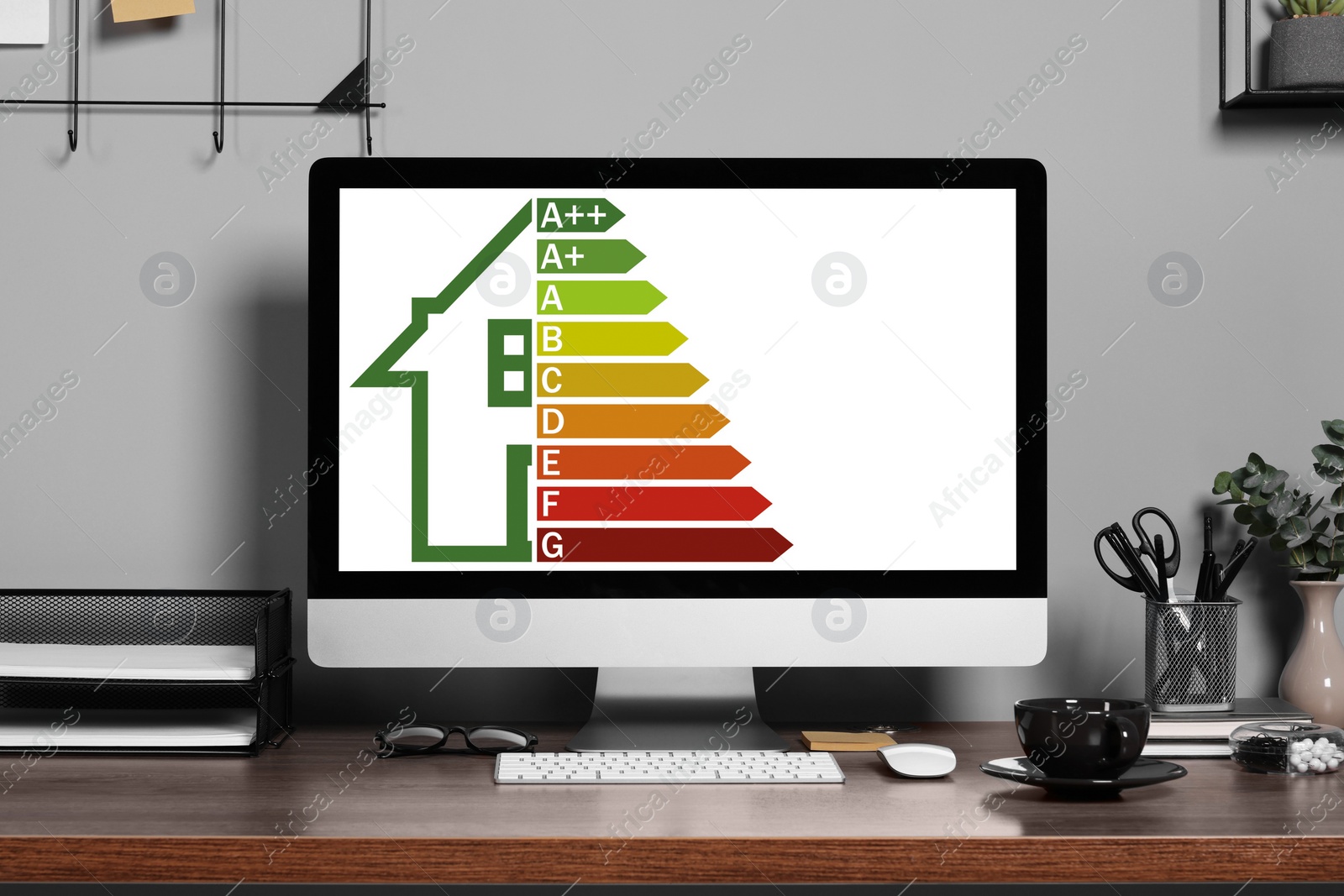 Image of Energy efficiency rating on display. Workplace with modern computer