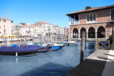 VENICE, ITALY - JUNE 13, 2019: Boats moored at pier in city