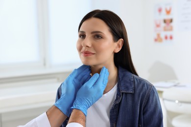 Endocrinologist examining thyroid gland of patient at hospital, closeup