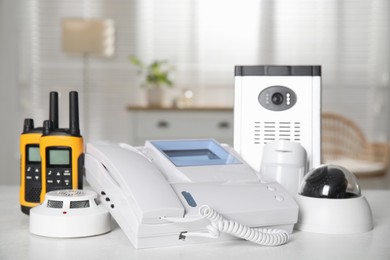 Photo of Different equipment for home security system on white table indoors