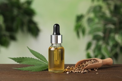 Bottle of CBD oil, hemp leaf and seeds on wooden table