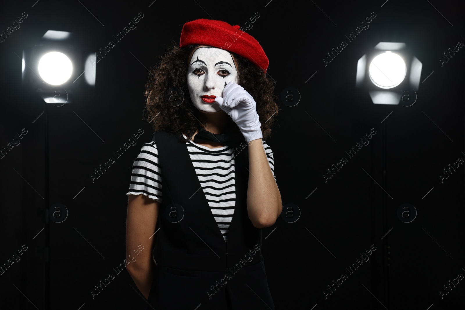 Photo of Young woman in mime costume performing on stage