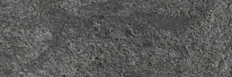 Texture of dark grey stone surface as background, closeup. Banner design