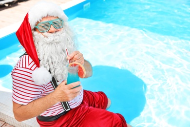 Authentic Santa Claus with cocktail near pool at resort