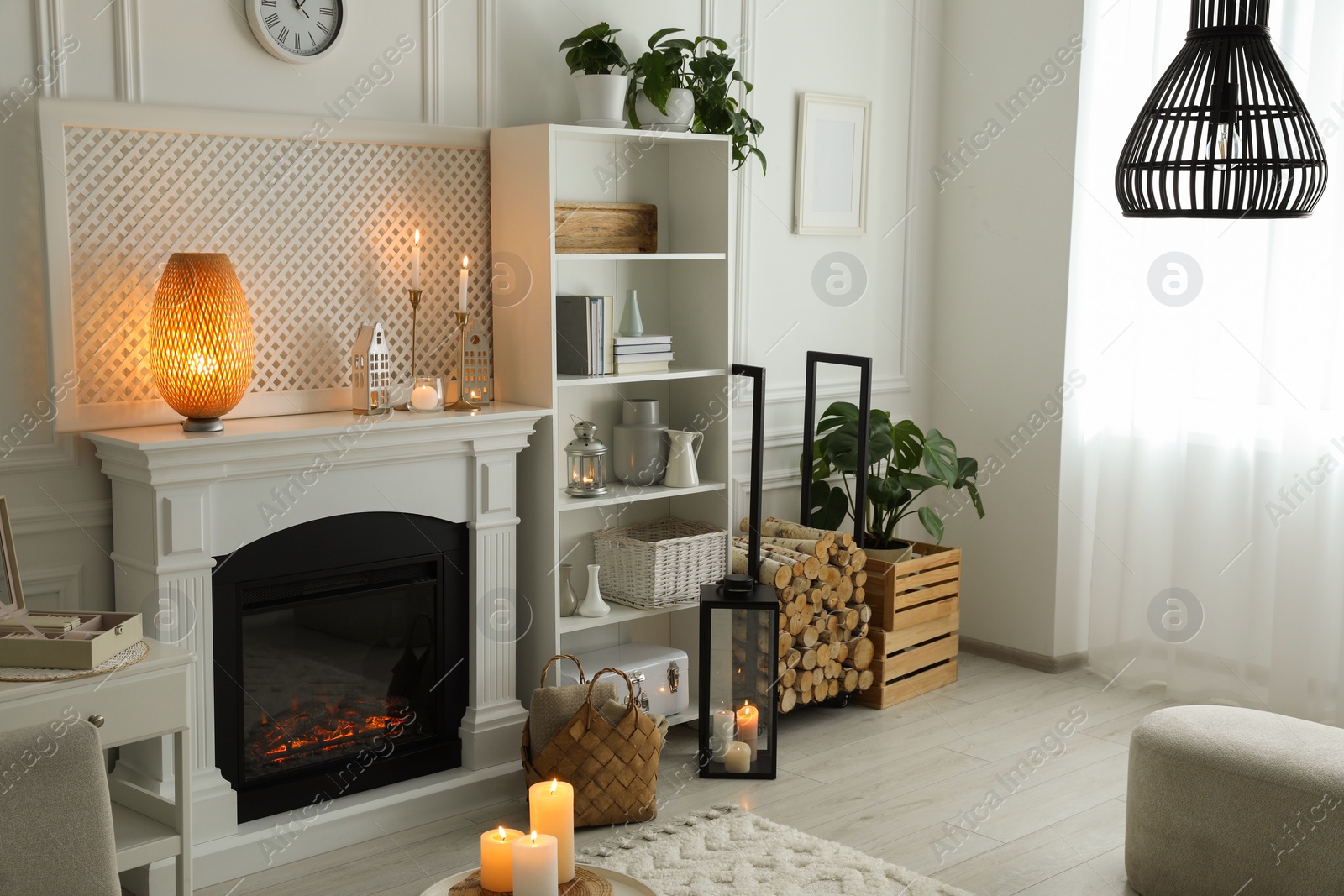 Photo of Stylish living room with beautiful fireplace and different decor. Interior design