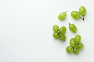 Fresh grapes on white background, top view. Space for text