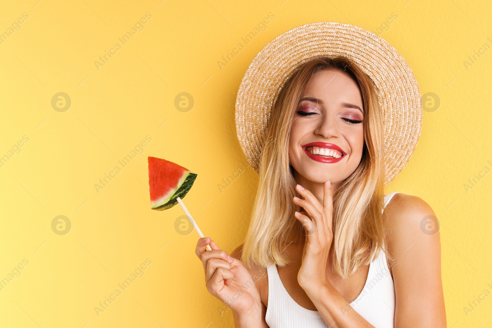 Photo of Pretty young woman with juicy watermelon on color background