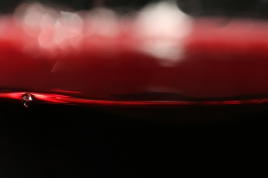 Photo of Delicious red wine in glass as background, closeup