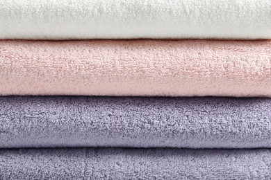 Photo of Stack of fresh folded towels as background, closeup