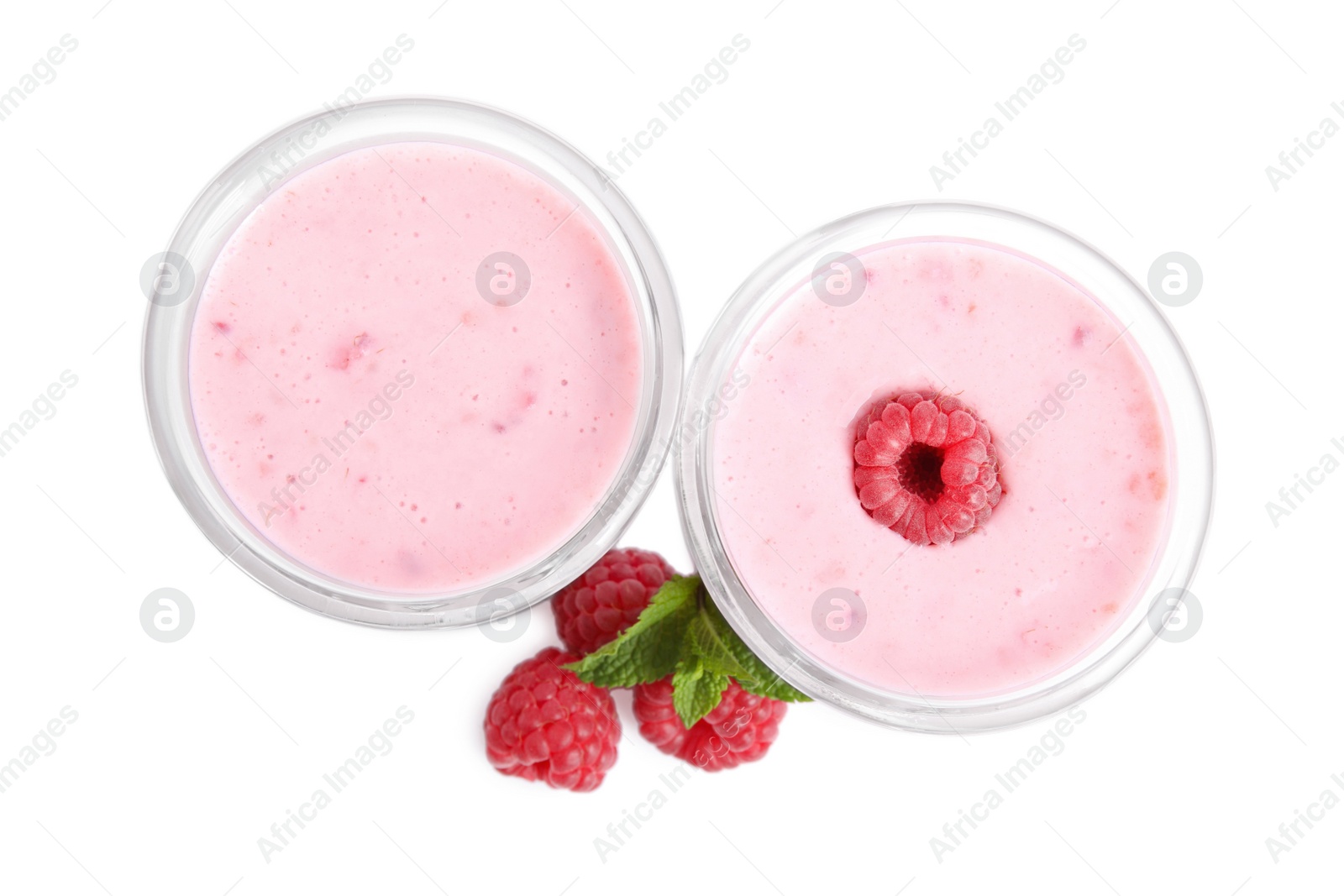 Photo of Tasty fresh raspberry smoothie in glasses on white background, top view