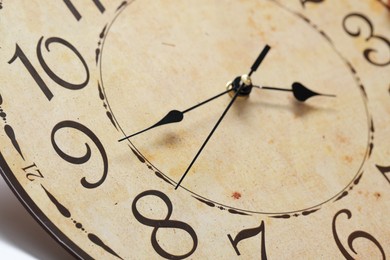 Photo of Stylish round clock on white background, closeup. Interior element