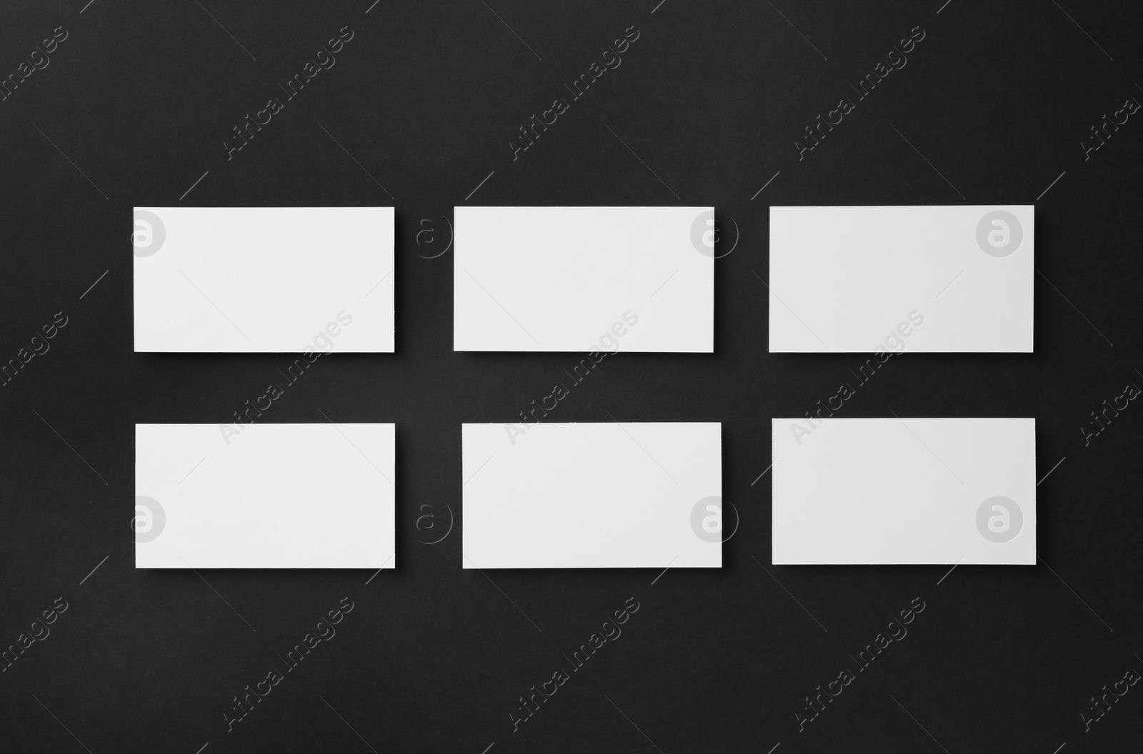 Photo of Blank business cards on black background, flat lay. Mockup for design